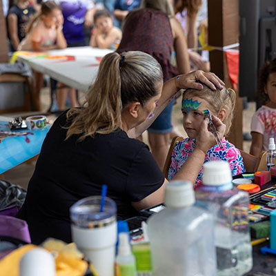 Child gets face painted at Paintchoo Plaza. Photo: Fili Creative