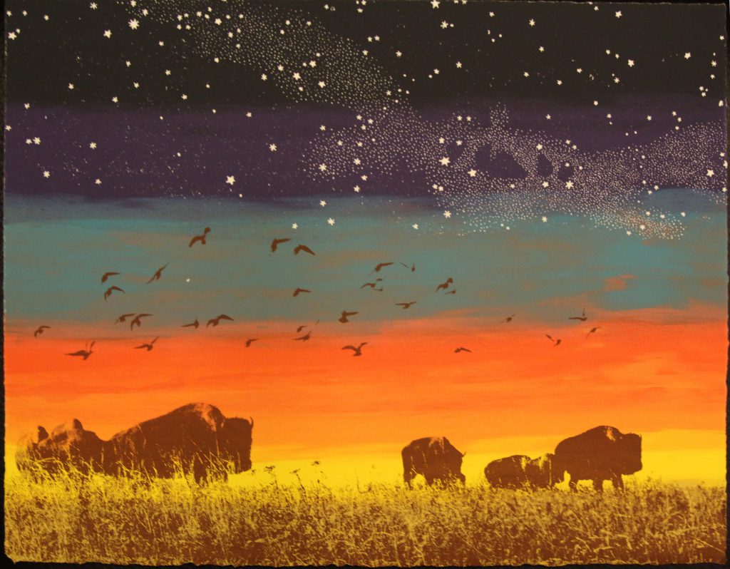 Fiery sunset over buffalo grazing the Kansas prairie.